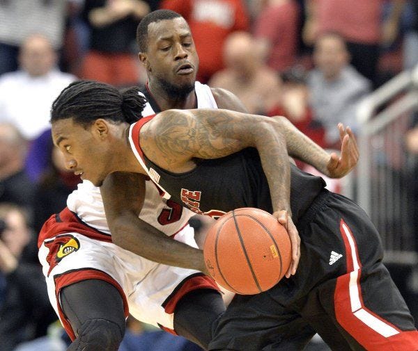 N.C. State's Cat Barber drives against the defense of Louisville's Chris Jones in Saturday's game. Barber led State with 21 points.