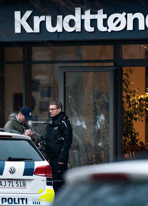 The scene outside the Copenhagen cafe, with bullet marked window, where a gunman opened fire Saturday, Feb. 14, 2015, in what is seen as a likely terror attack against a free speech event organized by an artist who had caricatured the Prophet Muhammad. The police believe there was only one shooter in the attack on a Copenhagen cafe that left one person dead and three police officers wounded during a free speech event. (AP Photo/Polfoto, Janus Engel) DENMARK OUT