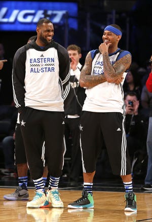 Eastern Conference All-Star LeBron James, left, of the Cleveland Cavaliers, and Carmelo Anthony, of the New York Knicks, talk during practice for the NBA All-Star game Saturday in New York. AP Photo/Julio Cortez