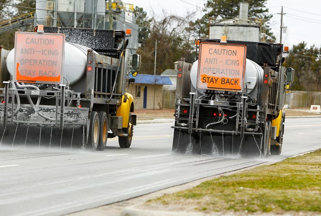 Department of North Carolina Transportation in Jacksonville lay down Brine a salt and water mixture along Bell Fork Road in Jacksonville on Monday.