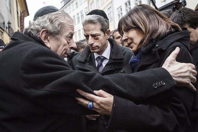 Former Chief Rabbi Bent Melchior, left, embraces Paris Mayor Anne Hidalgo with French Chief Rabbi Moise Lewin at centre, during a visit the Synagogue in Copenhagen, Monday, Feb. 16, 2015, after the attacks at the weekend. The slain gunman suspected in the deadly Copenhagen attacks was a 22-year-old with a history of violence and Danish authorities say he may have been inspired by Islamic terrorists — and possibly the Charlie Hebdo massacre in Paris. (AP Photo/Polfoto, Stine Bidstrup)