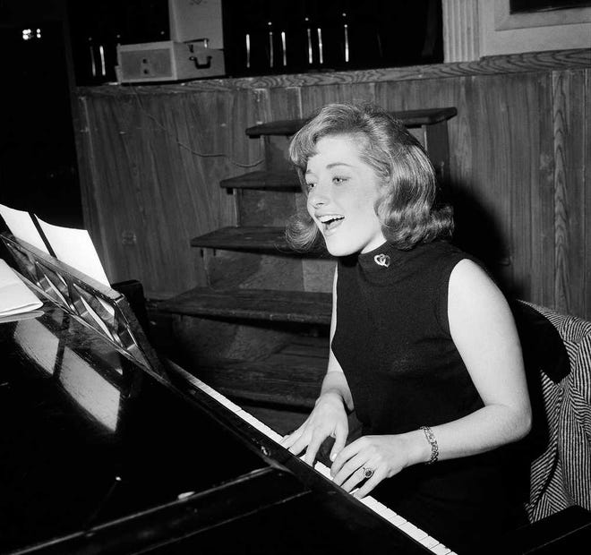 FILE - In this Jan. 5, 1966, file photo, singer Lesley Gore rehearses at a piano, in New York. Singer-songwriter Gore, who topped the charts in 1963 with her epic song of teenage angst, "It's My Party," and followed it up with the hits "Judy's Turn to Cry," and "You Don't Own Me," died of cancer, Monday, Feb. 16, 2015. She was 68. (AP Photo/Dan Grossi, File)