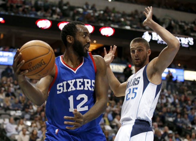 76ers forward Luc Mbah a Moute looks to make a pass as the Mavericks' Chandler Parsons defends during a Nov. 13 game.