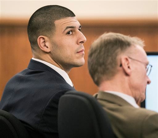 Aaron Hernandez sits with his attorney Charles Rankin during the former New England Patriots football player's murder trial, Friday, Feb. 13, 2015, in Fall River, Mass. Hernandez is charged with killing semiprofessional football player Odin Lloyd.