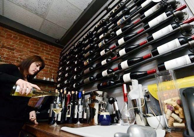 Stephanie Steele pours wine at the Annex Wine Bar on Feb. 12 in Clinton. Hamilton College announced it had a $307 million regional economic impact, affecting many local businesses. GATEHOUSE NEW YORK PHOTO/MARK DIORIO