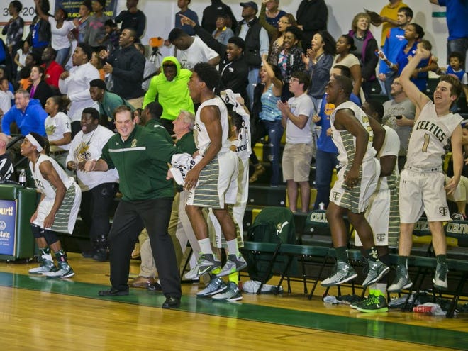 Trinity Catholic's bench reacts as the final buzzer sounds in their 42-41 win over P.K. Yonge in the Region 4A-2 semifinals at Trinity Catholic HS on Tuesday.