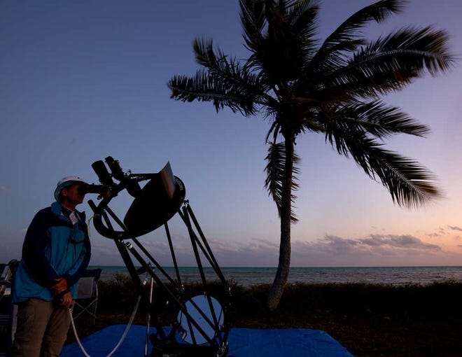In this Monday, Feb. 16, 2015, photo provided by the Florida Keys News Bureau, David Frizzell adjusts his telescope at the 31st Winter Star Party on Scout Key, Fla. Frizzell, an Albuquerque, N.M., resident, is one of about 500 amateur and professional astronomers in the lower Florida Keys this week to observe southern constellations, comets and stars during the annual event that ends Sunday, Feb. 22. (AP Photo/Florida Keys News Bureau, Rob O'Neal)