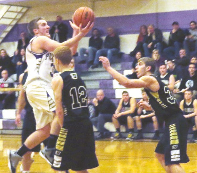 Pickford’s Ian Firack drives to the basket while Jeremiah Anderson (12) and Gage Kreski (34) defend during a boys basketball game Monday night.