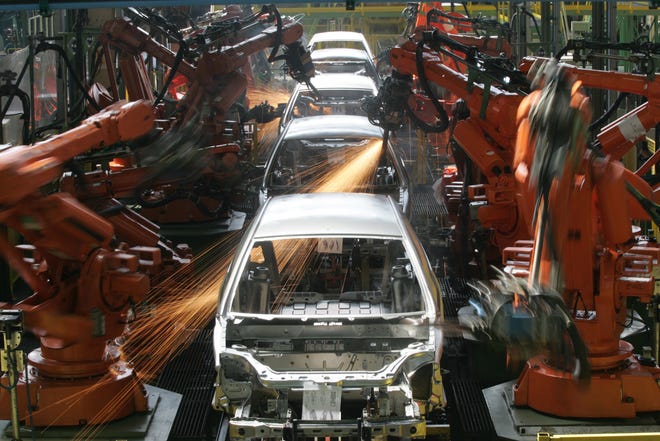 An automated Ford assembly line in Brazil is seen in 2008. With automation moving into high-tech roles, more jobs will suffer, a new study says.

Andre Penner/The Associated Press