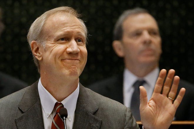 Illinois Gov. Bruce Rauner delivers his State of the Budget address to a joint session of the General Assembly in the House chambers, Wednesday, Feb. 18, 2015, in Springfield Ill. Rauner called for deep spending cuts to Medicaid, pensions and other programs to fix the state's budget mess without raising taxes. (AP Photo/Seth Perlman)