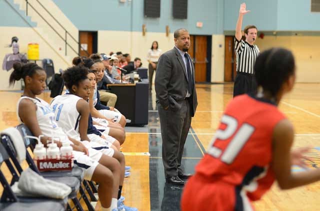 Lenoir Community College women’s basketball coach Tad Parson keeps his eyes on the court during a game this season. Parson has no assistant coaches and has to try and remained focused on coaching the basketball game, while handling other facets of coaching.