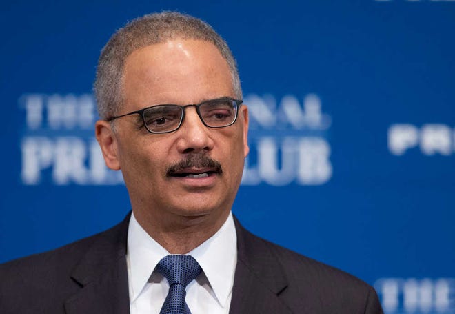 Attorney General Eric Holder speaks at the National Press Club in Washington, Tuesday, Feb. 17, 2015. The Obama administration put its new deportation relief program on hold on the eve of enactment Tuesday, complying reluctantly with a federal judge's order blocking it that roiled immigrant communities nationwide and seemed to harden a tense stalemate on Capitol Hill. Holder said the Justice Department was still in the process of looking at the opinion and deciding what steps to take. (AP Photo/Manuel Balce Ceneta)