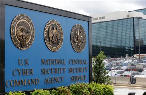 In this June 6, 2013, file photo, a sign stands outside the National Security Administration (NSA) campus in Fort Meade, Md. Britain's electronic spying agency, in cooperation with the NSA, hacked into the networks of a Dutch company to steal codes that allow both governments to seamlessly eavesdrop on mobile phones worldwide, according to the documents given to journalists by Edward Snowden. (AP Photo/Patrick Semansky, File)