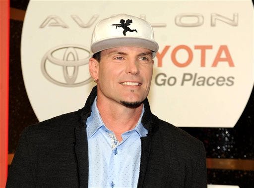 In this Nov. 8, 2013 file photo, recording Artist Vanilla Ice arrives at the 2013 Soul Train Awards at the Orleans Arena in Las Vegas. Police in the Palm Beach County town of Lantana, Fla., say the recording artist and home-improvement-show host has been charged with breaking into and stealing from an abandoned home that is in foreclosure. They said in a news release that some of the items stolen were found at his property. Vanilla Ice, whose real name is Robert Van Winkle, rose to fame following the 1990 release of the hit song "Ice Ice Baby." In recent years, he has hosted "The Vanilla Ice Project" on DIY Network. (Photo by Frank Micelotta/Invision/AP, File)