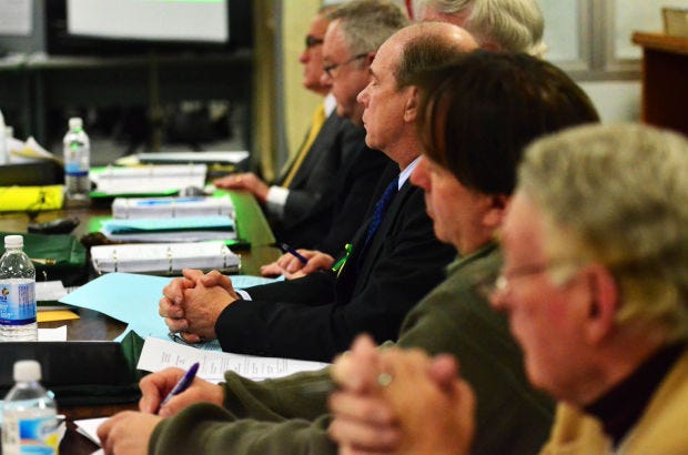 Members of the Blackhawk School Board listen to public criticism during a February 2014 meeting.
