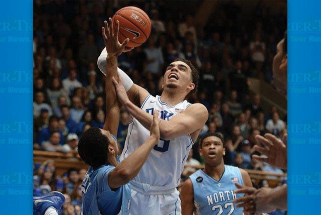 GOING TO THE LINE — Duke guard Tyus Jones is fouled by UNC’s Nate Britt during overtime.