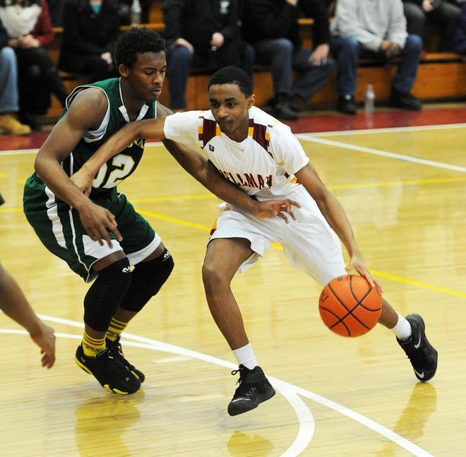 Cardinal Spellman's Admar Jaramillo, right, dribbles past Cathedral defender Julien Howell in the first quarter of a high school basketball game in Brockrton on Thursday, Feb. 19, 2015.