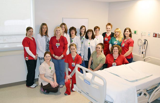 Staff members from the nursing, rehabilitation and hospital services departments gather in one of the new patient rooms on the expanded orthopedic unit at St. Elizabeth Medical Center. SUBMITTED PHOTO