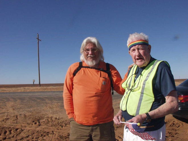 Runners Carlos Cano, left, and Ernie Andrus prepare to hit the road a few miles southwest of Lamesa.