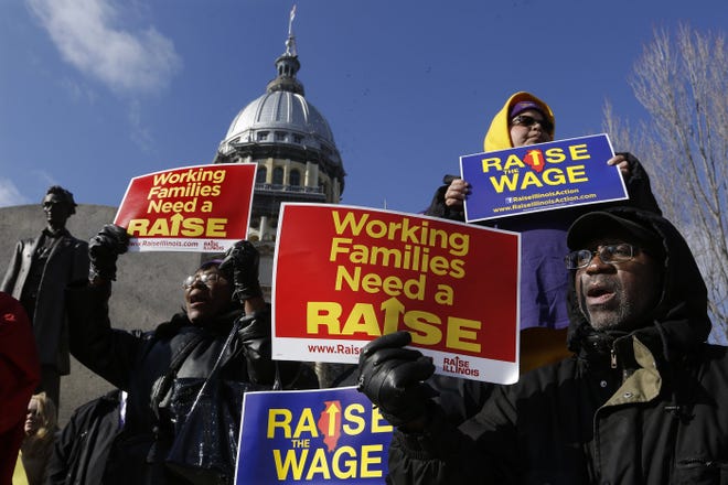 In this Nov. 20, 2014, file photo, supporters of legislation that will raise the minimum wage in Illinois rally outside the Illinois State Capitol in Springfield Ill. Most Americans support increasing the minimum wage, as well as requiring employers to provide paid sick leave and parental leave, according to a new Associated Press-GfK poll. Proposals to increase the federal minimum wage, as well as to require employers to give paid leave to their employees, find few objections among Americans as a whole.
