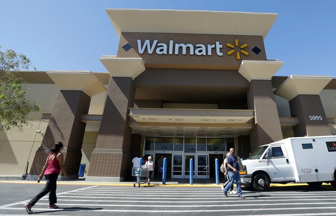 In this Sept. 19, 2013 file photo, customers walk outside of a Walmart store in San Jose, Calif. Wal-Mart Stores Inc. announced Thursday it is spending $1 billion to make changes to how it pays and trains hourly workers as the embattled retailer tries to reshape the image that its stores offer dead-end jobs.