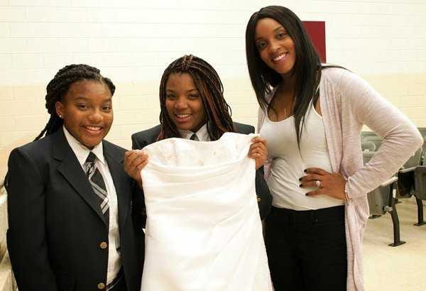 Provided by Erica La Spada Destiny Briggs (from left) joins Skiijanee Claridy as she holds up a dress being donated by Chanel Shorts.