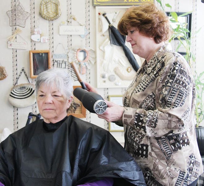 Debbie Craddock, shown here working on a customer’s hair, has been in business in Fairbury for 25 years.