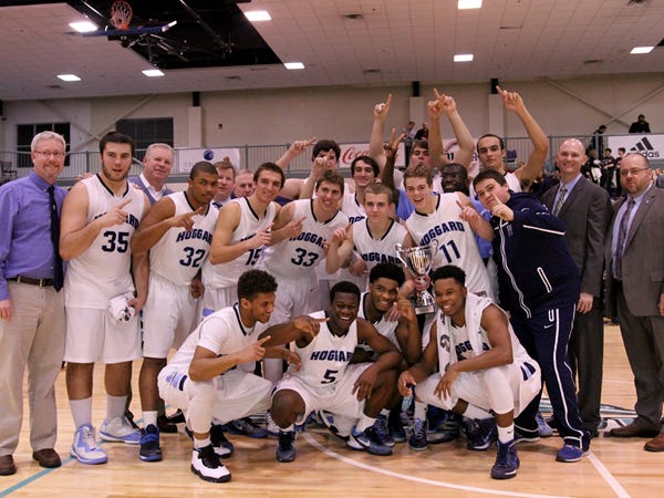 Hoggard players and coaches celebrate a 75-66 win against the West Brunswick Trojans in the MEC Championship game held at Brunswick Community College in Supply on Friday, February 20, 2015.
