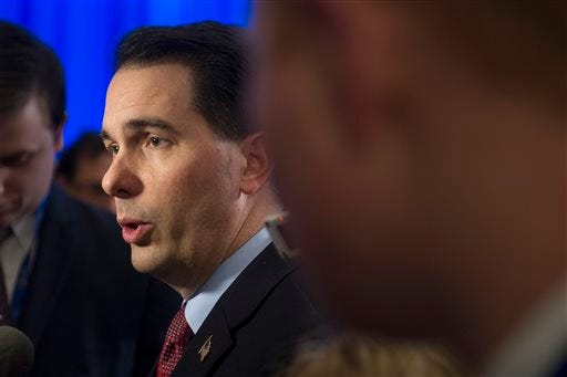 Wisconsin Gov. Scott Walker speaks with reporters at the conclusion of the opening session of the National Governors Association Winter Meeting in Washington, Saturday, Feb. 21, 2015. (AP Photo/Cliff Owen)