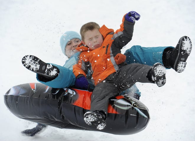 NORTH FALMOUTH -- Talor Cecil of Falmouth and her son, Samuel Olin, 5, brace themselves as they hit the snow ramp sledding at North Falmouth Elementary School in this photo from January of 2012.