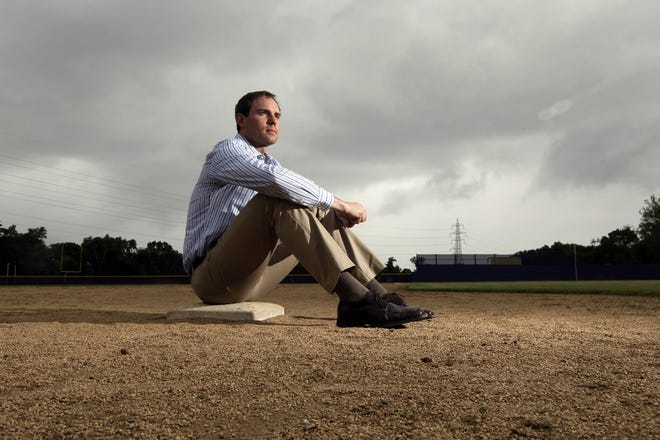Garrett Broshuis, now a lawyer, on a base in St. Louis in 2013. The former minor league pitcher says organized baseball violates wage law for minor league players. "It seemed like it was just a meat market, the true commoditization of human beings."

AP /Jeff Roberson