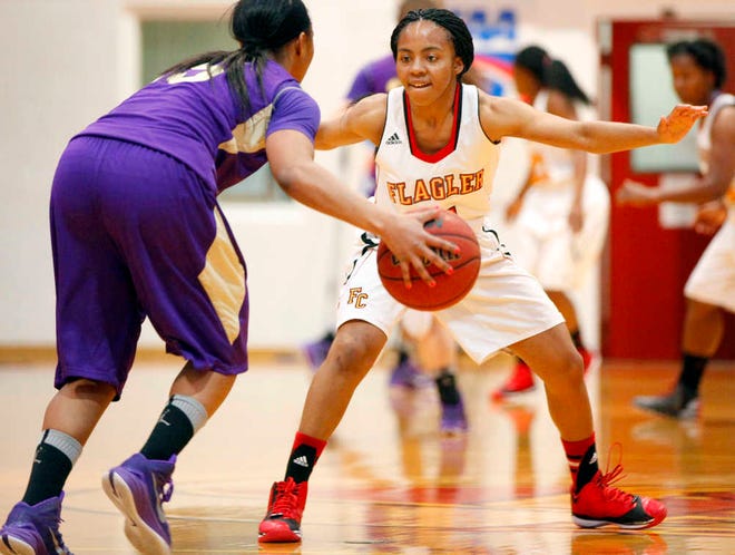 DARON.DEAN@STAUGUSTINE.COM Flagler's DeAsha Campbell plays defense against Montevallo's Carrington Caise during women's NCAA basketball in Flagler's gymnasium Saturday afternoon, February 21, 2015.