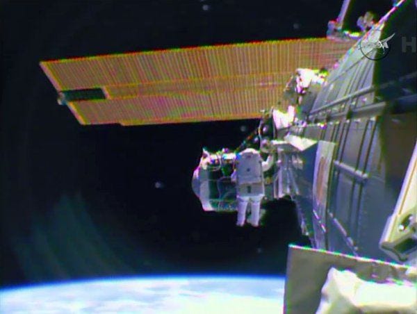 Astronaut Barry "Butch" Wilmore begins the spacewalk Saturday to wire the International Space Station in preparation for the arrival in June of the international docking port for crew vehicles.