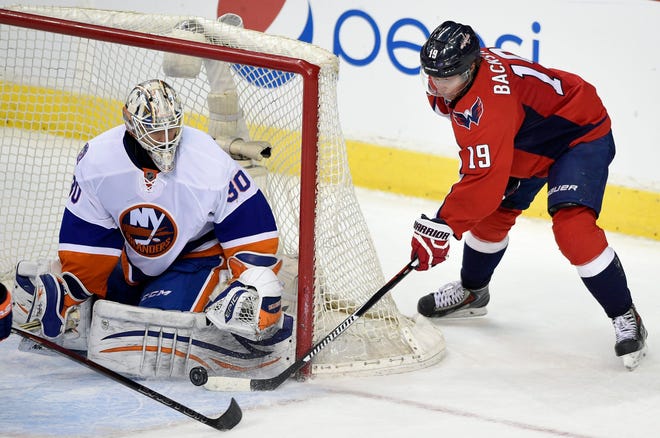 Washington Capitals center Nicklas Backstrom gets stopped by Islanders goalie Chad Johnson during Saturday's game in Washington. The Islanders lost, 3-2, in a shootout.