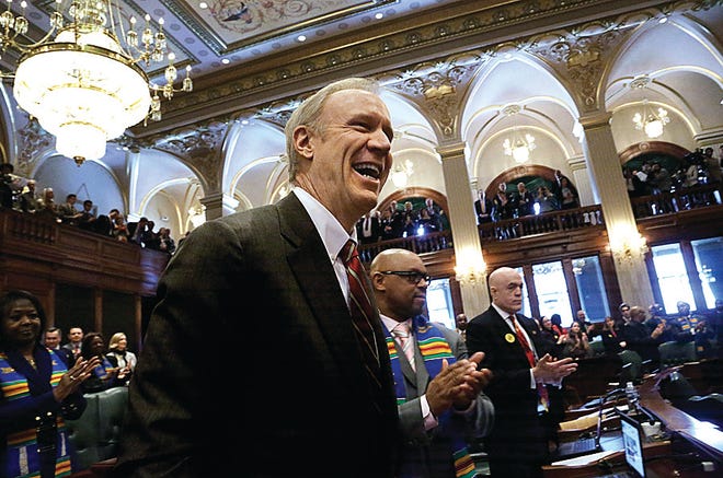 Lawmakers applaud Illinois Gov. Bruce Rauner on Wednesday before he delivers his State of the Budget Address to a joint session of the General Assembly in the House chambers in Springfield. Rauner's first budget proposal seeks $1.5 billion in cuts to Medicaid. The way he gets there shows he's willing to go toe-to-toe with three powerful business lobbies: retail pharmacies, nursing homes and hospitals.