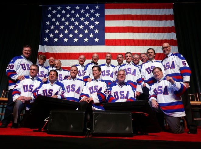 Members of the 1980 U.S. ice hockey team pose for photos after a "Relive the Miracle" reunion at Herb Brooks Arena on Saturday, Feb. 21, 2015, in Lake Placid, N.Y. Every surviving member of the hockey team returned to the hockey rink on Main Street they made famous with one of the most memorable upsets in sports history.