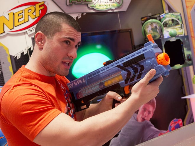L.J. Cunningham demonstrates a Nerf Rival Zeus MXV-1200 blaster by Hasbro at the North American International Toy Fair on Saturday, Feb. 14, 2015 in New York. The new blaster toys are aimed at the older teen market. AP/Mark Lennihan