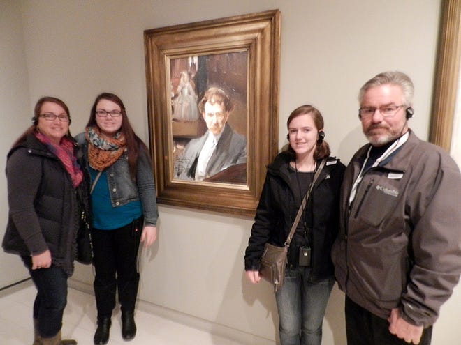 Scott Stephens (right) poses with his wife, Joyce (left)and daughters Carly and Libby in front of the Ralph Clarkson portrait while on view at the Fundacion MAPFRE art museum in Madrid, Spain, in December 2014. The painting is now back at the Oregon Public Library, where it can be seen with other works of art. PHOTO PROVIDED