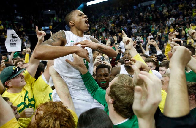 Oregon's Joseph Young is hoisted by fans after Oregon defeated No. 9 Utah 69-58 in the NCAA basketball game at Matthew Knight Arena in Eugene, Ore., Sunday, Feb. 22, 2015. Young scored 14 points in the game. (AP Photo/The Register-Guard, Andy Nelson)