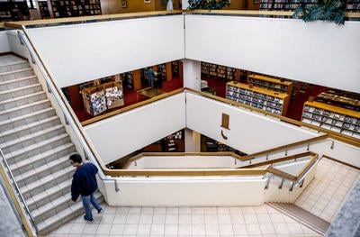 A visitor makes his way up the stairs in the lightwell at Lincoln Library in downtown Springfield. File/The State Journal-Register