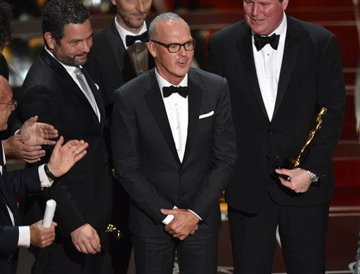 Michael Keaton, center, and the cast and crew of “Birdman or (The Unexpected Virtue of Ignorance)” accept the award for the best picture at the Oscars on Sunday, Feb. 22, 2015, at the Dolby Theatre in Los Angeles.