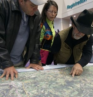 John Lovett • Times Record
Robin Cameron, left, Pat Poole and John Poole of Crawford County review a map of the proposed route for the Plains & Eastern Clean Line on Wednesday, Feb. 18, 2015, at the Fort Smith Convention Center during a U.S. Department of Energy Draft Environment Impact Study public comment event concerning Houston-based Clean Line Energy Partners' proposed route of a 720-mile high-voltage, direct-current transmission line. At least 450 people from western Arkansas and eastern Oklahoma turned out for the event. Cameron and the Pooles are opposed to the project. The proposed route places the line near their property north of Van Buren near Union Town Road.