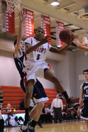 Sheldon Jeter (5) of Aliquippa drives past John Weldon (33) of Bishop Canevin to score during Monday's game.