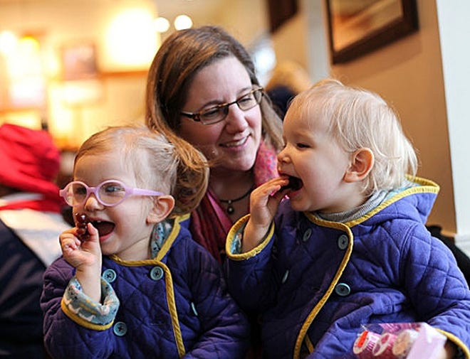 In a Feb. 9, 2015 photo, Michelle Moore poses for a photo with her twin daughters, Sierra, right, and Savannah in Lake Oswego, Ore. Moore is not opposed to medicine, thinks vaccines have a place and are a medical choice that should be researched carefully. Moore is among the vaccine skeptics who have been widely ridiculed since more than 100 people fell ill in a measles outbreak traced to Disneyland. GOSIA WOZNIACKA/AP PHOTO