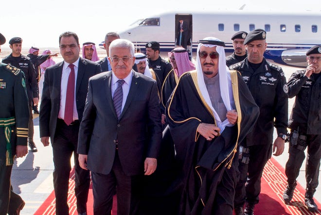 In this photo provided by the Saudi Press Agency, Saudi King Salman, center right, walks with Palestinian President Mahmoud Abbas on his arrival to Riyadh Airbase, Riyadh, Saudi Arabia, Monday. On Monday, the Palestinian Authority and the Palestine Liberation Organization were found liable by a jury in Manhattan for their role in knowingly supporting six terrorist attacks in Israel between 2002 and 2004 in which Americans were killed and injured.