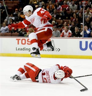 Detroit Red Wings center Darren Helm, top, leaps over center Pavel Datsyuk during the first period of an NHL hockey game against the Anaheim Ducks in Anaheim, Calif., Monday, Feb. 23, 2015. (AP Photo/Chris Carlson)