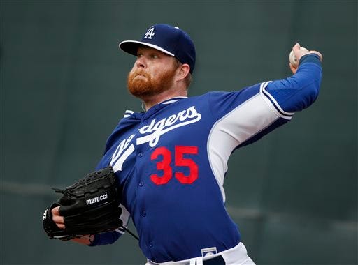 Los Angeles Dodgers' pitcher Brett Anderson throws a pitch during the team's first pitchers and catchers workout at spring training Friday, Feb. 20, 2015, in Phoenix. (AP Photo/John Locher)