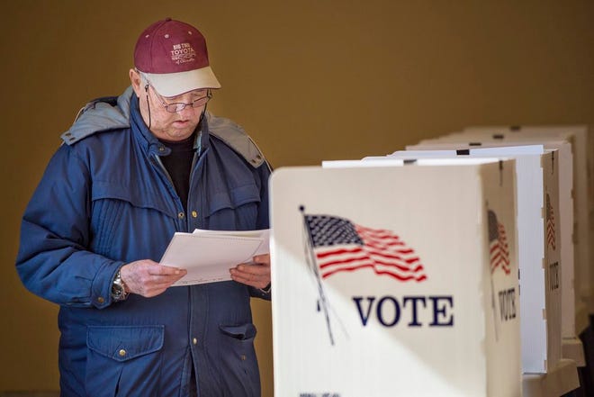 Robert E. Gordon checks his ballot before turning it in after voting in the Washington City Council primary election Tuesday.
