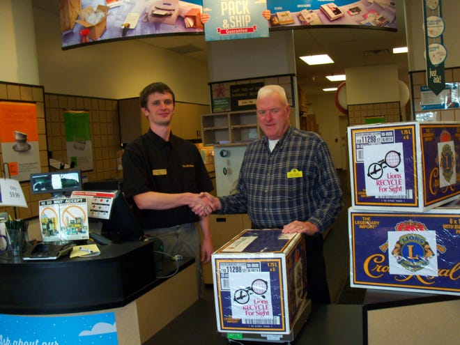 Doug Cain, new owner of the North Hampton UPS Store, and Dave Rogers, chairman of the Lions District 44H Used Eyeglass and Hearing Aid Committee, get ready to ship several boxes of used eyeglasses to Roanoke, Virginia.