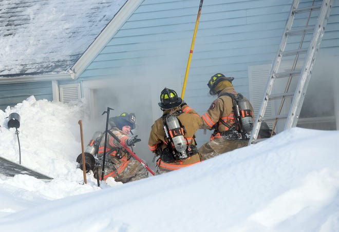 Firefighters fought against a fire at 68 Locke Road in Hampton Friday morning where tall snowbanks, chilling winds and frigid temps made it challenging.

Deb Cram/Seacoastonline